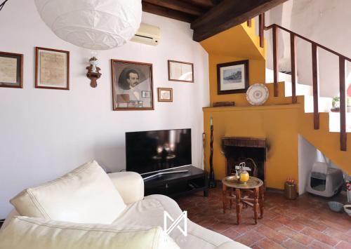 a living room with a couch and a fireplace at MyStay - A Casa do Visconde in Mértola