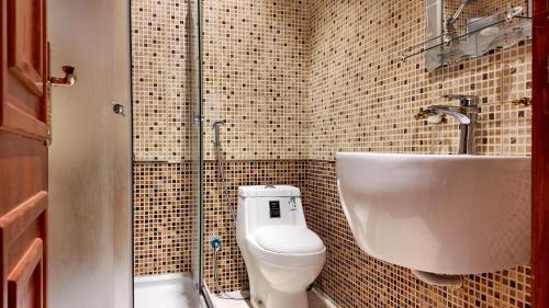 a bathroom with a toilet and a sink at Sada Compound (Women Only) سيدات فقط in Riyadh