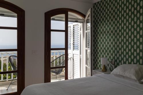 a bedroom with a bed and a view of a balcony at La Casa Nostra - family oriented house in quiet area in Bajamar