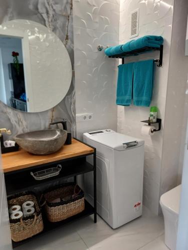 a bathroom with a sink and a toilet and a mirror at Apartamento Pepi Puerto (Adults Only) in Santa Pola