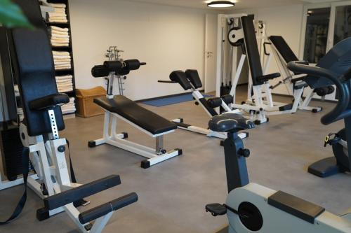 a gym with several exercise equipment in a room at Sporthotel Igls in Innsbruck