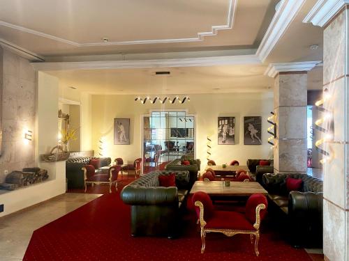 a living room with couches and a red rug at Sporthotel Igls in Innsbruck