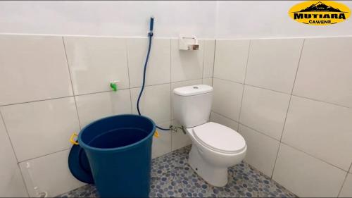 a bathroom with a toilet and a bucket at Villa Mutiara Cawene in Gunungpicung
