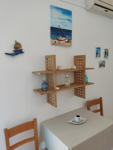 a dining room with a table and two chairs at Manolis Rooms Vathys in Kalymnos