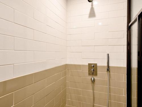 a shower with a glass door in a bathroom at Brown Dot Yangjeong in Busan