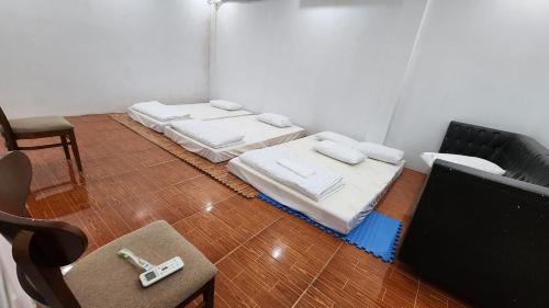 a room with three mattresses sitting on the floor at A Thía Hostel in Dien Bien Phu