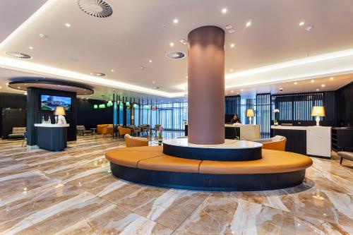 a lobby with a column in the middle of a room at Coastlands Skye Hotel, Ridgeside, Umhlanga in Durban