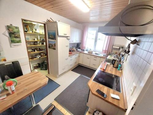 a kitchen with a refrigerator and a table in it at Feel comfortable in Vaihingen an der Enz