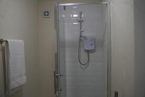 a shower in a bathroom with a glass door at Luxury Apartment in Luton in Luton