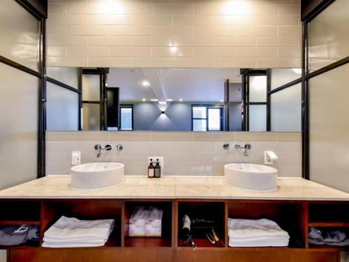 a bathroom with two sinks and a large mirror at Brown Dot Yangjeong in Busan