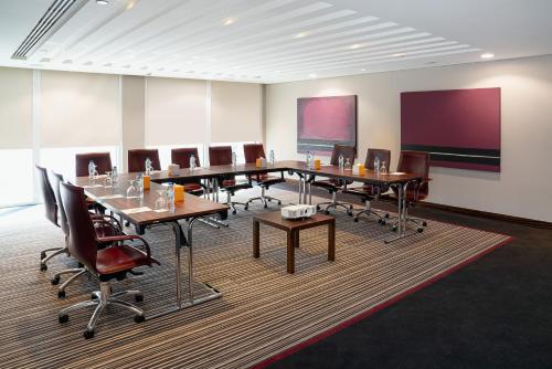 a conference room with a long table and chairs at Centro Al Manhal by Rotana in Abu Dhabi