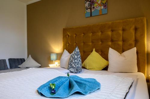 a blue towel sitting on top of a bed at Restaurant Appartements Almdiele in Hart im Zillertal