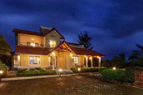 a house at night with lights in the driveway at Monica Farms - Monica Retreat in Waki