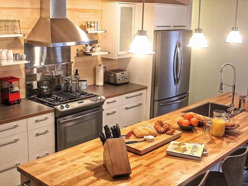 a kitchen with a counter top with a stove top oven at Destination Franc Sud Gaspésie in Cascapedia