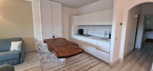 a kitchen with a wooden table in a room at LOTUS Wellness Apartment - Resort Ginestre - Palau - Sardinia in Palau