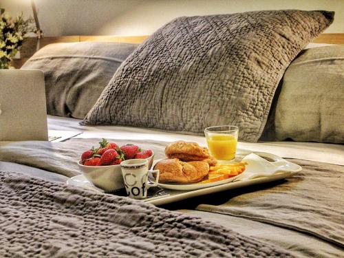 a breakfast tray with biscuits and fruit on a bed at Destination Franc Sud Gaspésie in Cascapedia