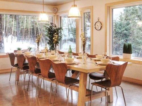 a large dining room with a table and chairs at Destination Franc Sud Gaspésie in Cascapedia