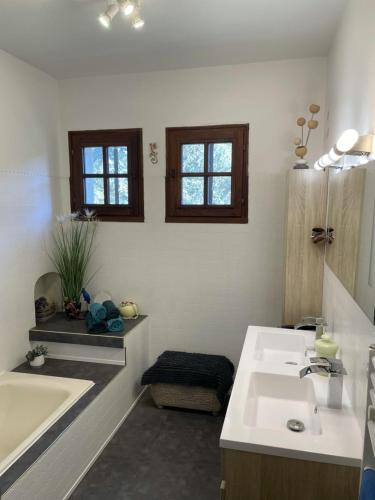 une salle de bain avec une baignoire et un lavabo et une baignoire dans l'établissement Bienvenue !, à Moissac