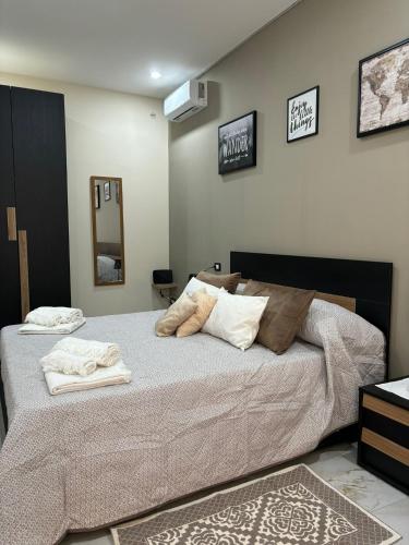 a bedroom with a large bed with towels on it at Little Dreams in Caserta