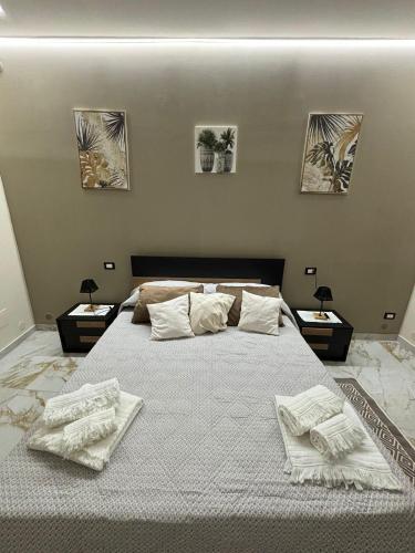 a bedroom with a large bed with white pillows at Little B&B in Caserta