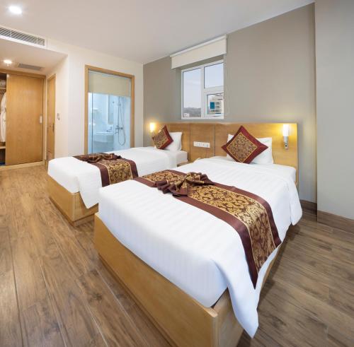 Postel nebo postele na pokoji v ubytování Gibson Hotel Nha Trang