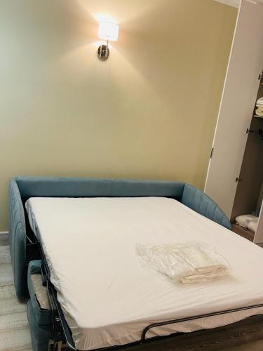 a hospital bed in a room with a light on the wall at LOTUS Wellness Apartment - Resort Ginestre - Palau - Sardinia in Palau