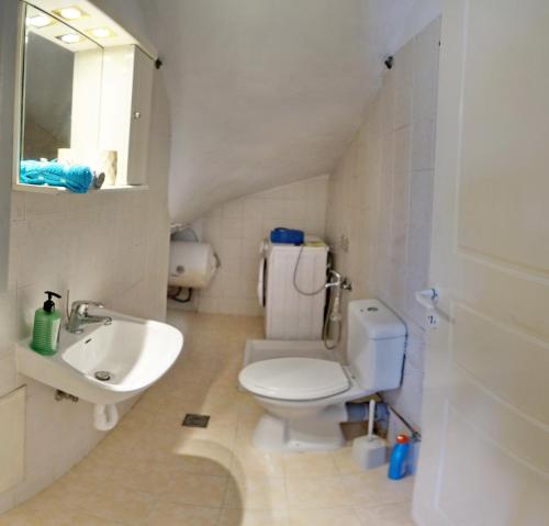 a bathroom with a toilet and a sink at Studios Akrotiri in Mytilini