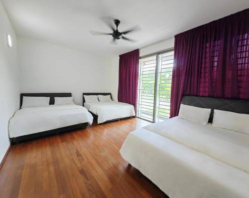 a bedroom with three beds and a ceiling fan at 162 Home4Stay Deluxe Big 3story 6Rooms 20pax Wedding USM Arena Bridge in Gelugor