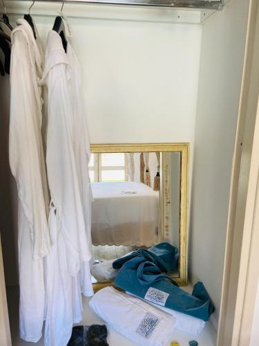 a room with a mirror and some clothes at LOTUS Wellness Apartment - Resort Ginestre - Palau - Sardinia in Palau