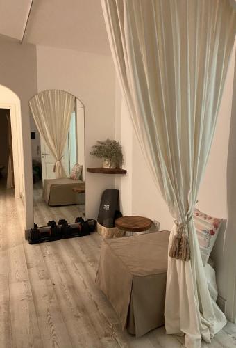 a living room with a curtain and a mirror at LOTUS Wellness Apartment - Resort Ginestre - Palau - Sardinia in Palau