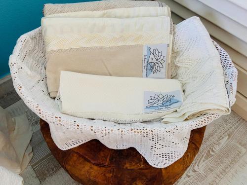 a basket filled with towels on top of a barrel at LOTUS Wellness Apartment - Resort Ginestre - Palau - Sardinia in Palau