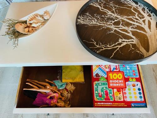 a box of toys on a table with a cake at LOTUS Wellness Apartment - Resort Ginestre - Palau - Sardinia in Palau
