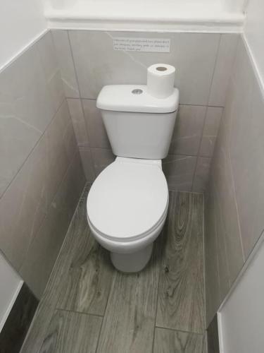 a bathroom with a toilet with a roll of toilet paper at Single Room Shared bathroom Free Street Parking Near Anfield LFC in Liverpool