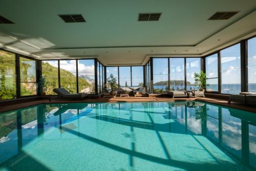 a swimming pool in a house with windows at Hotel Imperial Conference & Spa in Budva