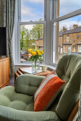 a living room with a couch and a large window at CRAVEN VUE - SKIPTON in Skipton