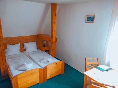 a bedroom with a bunk bed and a desk at Hotel Esprit in Špindlerův Mlýn
