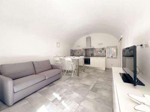 a living room with a couch and a kitchen at Appartamento del centro in Lerici