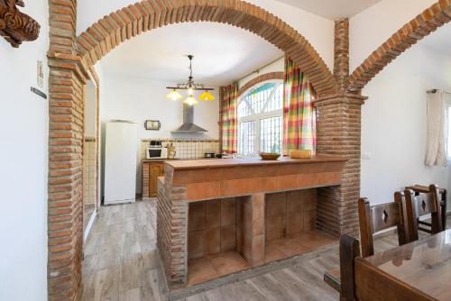 an archway in a kitchen with a brick wall at Villa Terrenito Private Pool by AORA STAY in Fuengirola