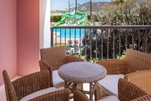 a balcony with a table and chairs and a slide at Melia Villaitana in Benidorm
