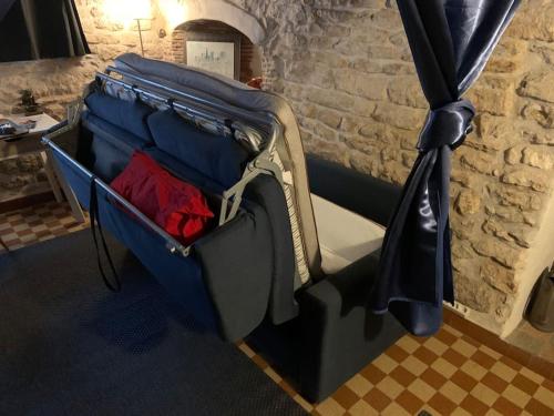 an open suitcase sitting in a room at Ferme du 17ème siècle et jardin in Druyes-les-Belles-Fontaines