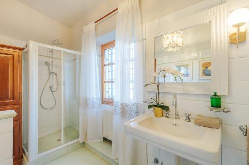 a white bathroom with a sink and a shower at Villa Amore, a Romantic Hilltop Farmhouse in Lucca in Lucca