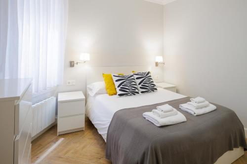 een slaapkamer met een bed met handdoeken erop bij VT Anboto by Bilbaohost in Bilbao