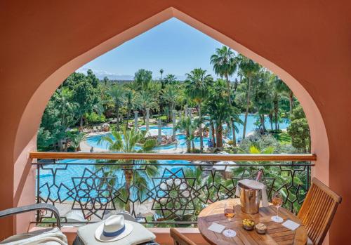a view of the pool from the balcony of a resort at Es Saadi Marrakech Resort - Palace in Marrakech