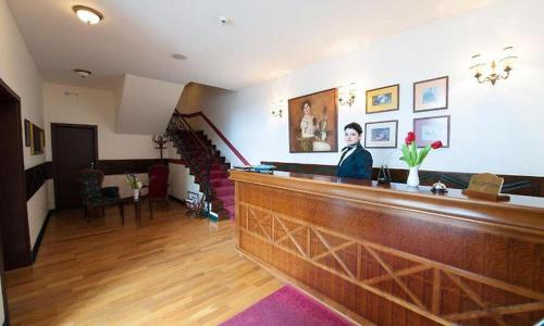 a man sitting at a bar in a room at Hotel Ana in Arad