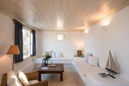 a living room with a couch and a table at Traditional Cycladic House 2 in Mykonos in Panormos Mykonos