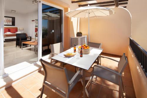 een eetkamer met een witte tafel en stoelen bij Mijas Costa Blue Sky Sea Views by ALFRESCO STAYS in Mijas Costa
