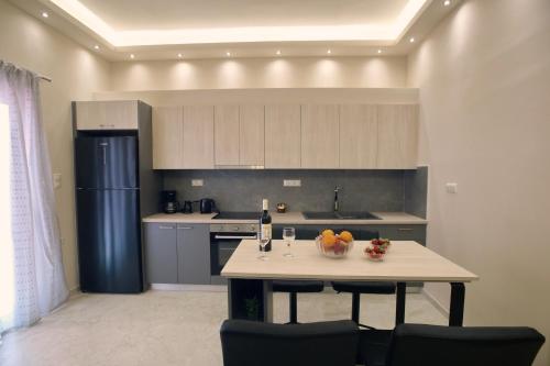 a kitchen with a table with a bowl of fruit on it at Libra Apartment in Nafplio in Nafplio
