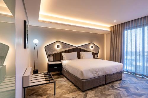 a bedroom with a large bed and a large window at Coastlands Skye Hotel, Ridgeside, Umhlanga in Durban