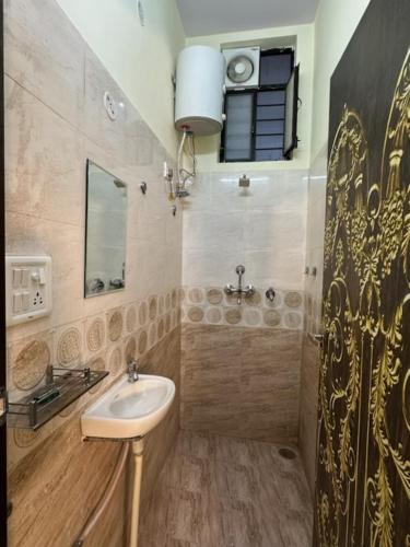a bathroom with a sink and a mirror at Jaipur Heritage Haveli in Jaipur