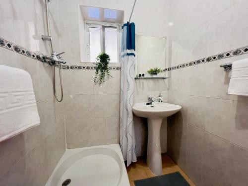 a white bathroom with a toilet and a sink at Casa Godoy con piscina by At Home Costa del Sol in Río